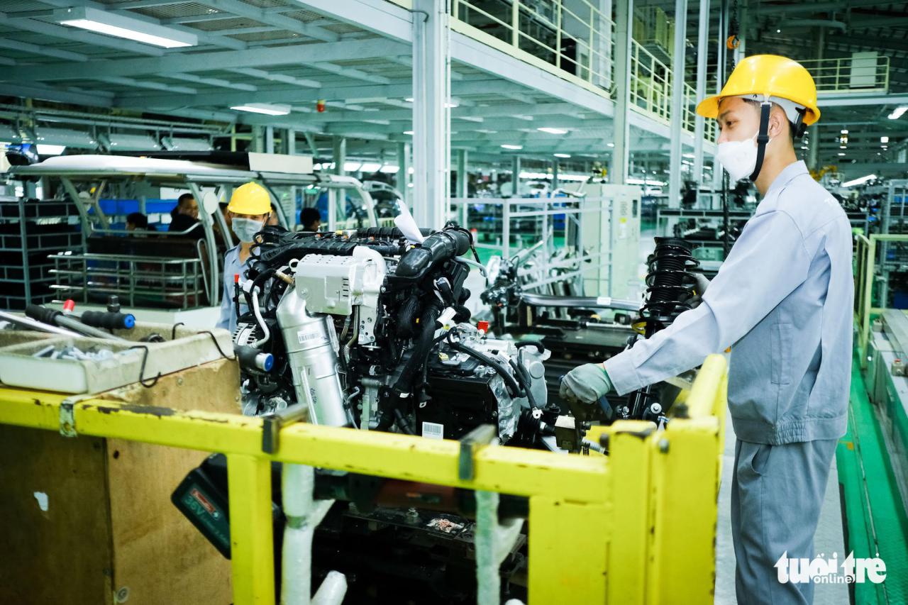 <em>Employees work on an automobile assembly line at THACO Chu Lai factory in Quang Nam Province, Vietnam. Photo:</em> Tan Luc / Tuoi Tre